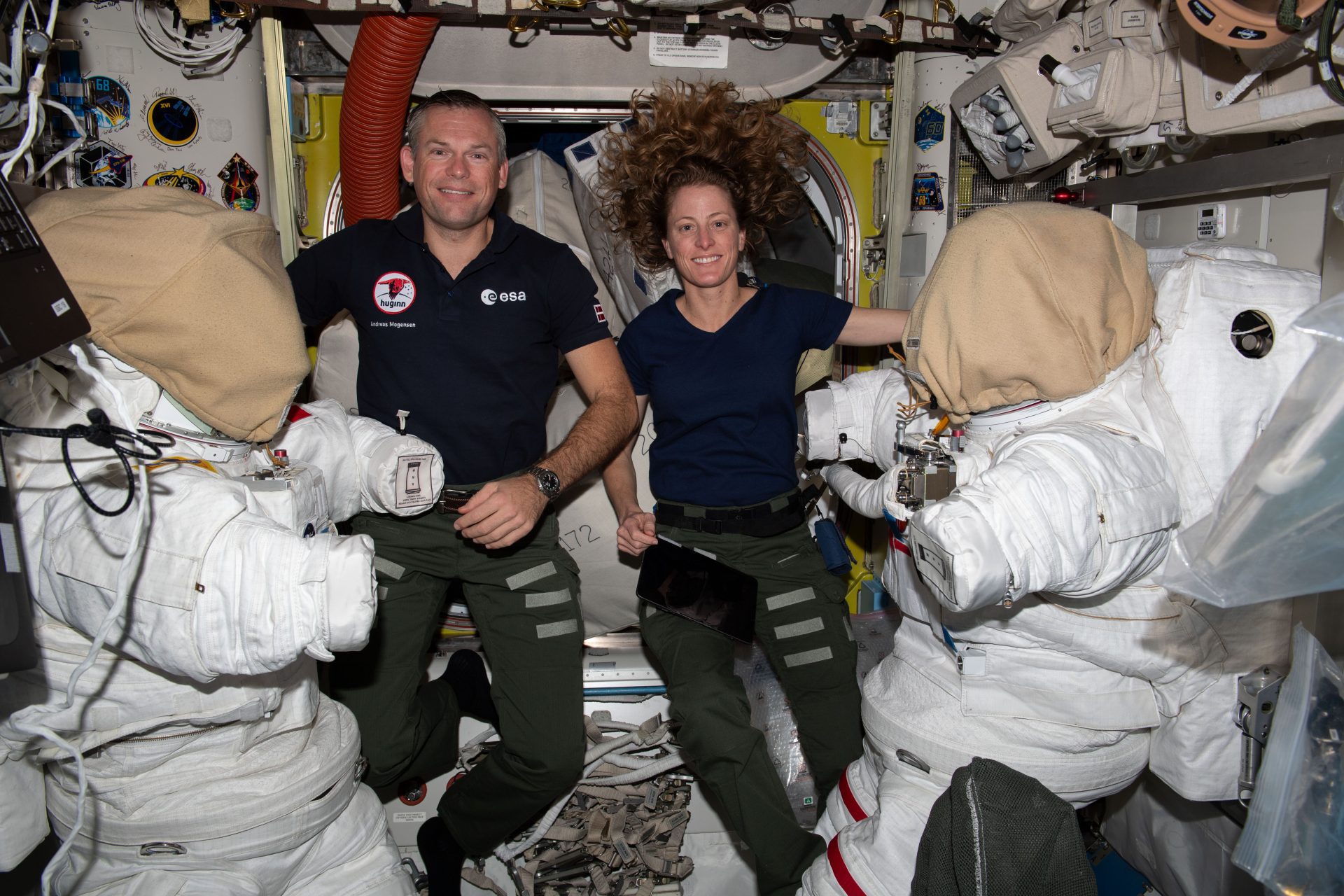 Astronauts Andreas Mogensen of ESA (European Space Agency) and Loral O'Hara of NASA service spacesuits inside the Quest airlock. The duo took turns cleaning cooling loops inside the suits ahead of a spacewalk planned for Oct. 12 to collect microbe samples from specific areas outside of the International Space Station. Scientists want to analyze the types of microbes that may be able to survive the harsh environment of outer space.