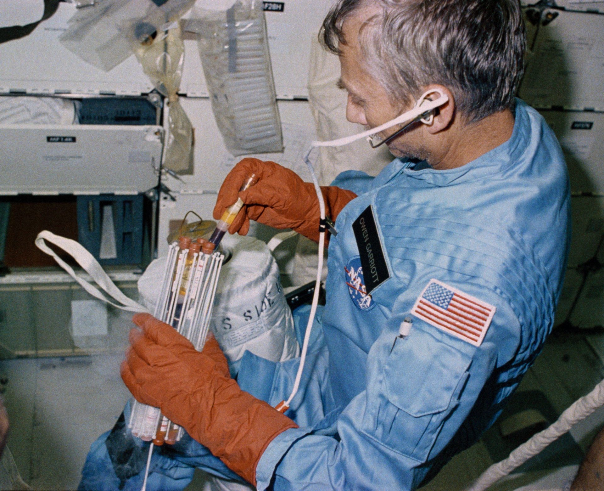 Owen K. Garriott prepares to place blood samples in a passive freezer