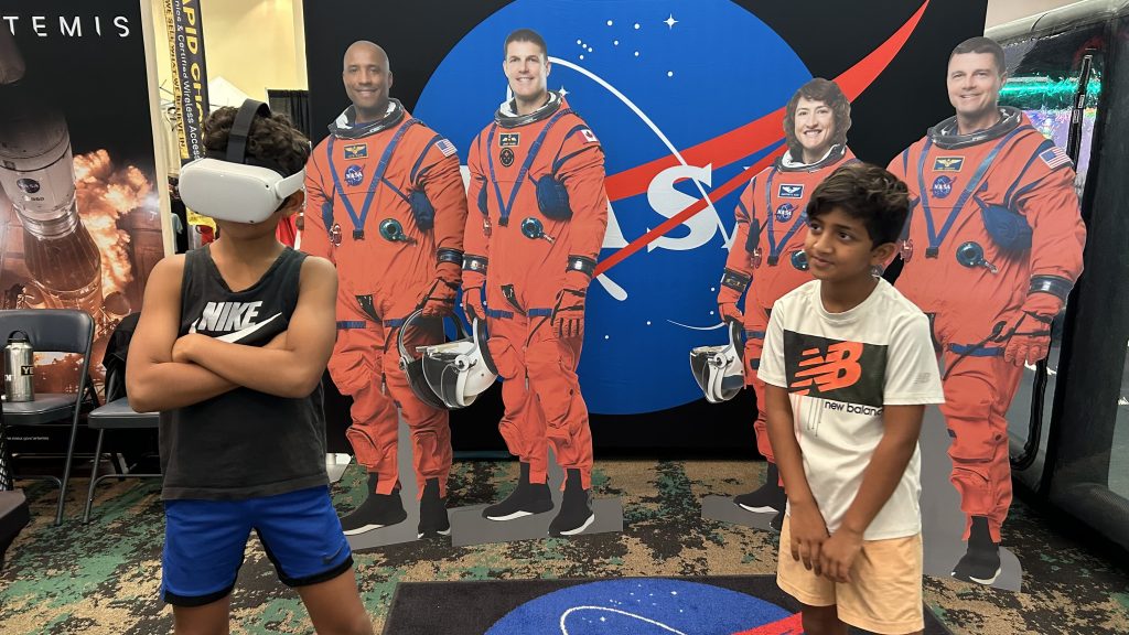 Two young participants enjoy a virtual reality space experience provided by NASA Stennis at the 28th Annual Cruisin’ the Coast car show