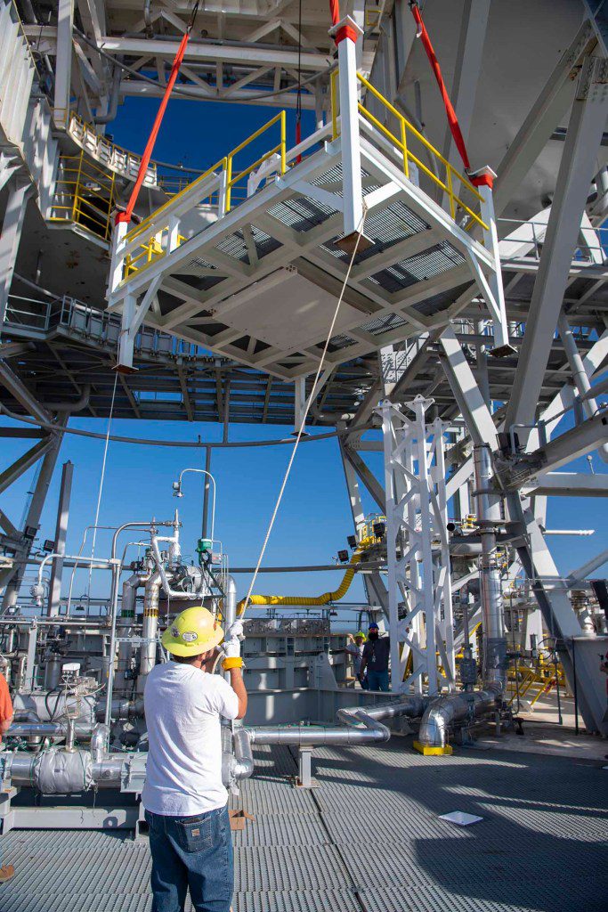 crew members working to secure the umbilical support structures in place