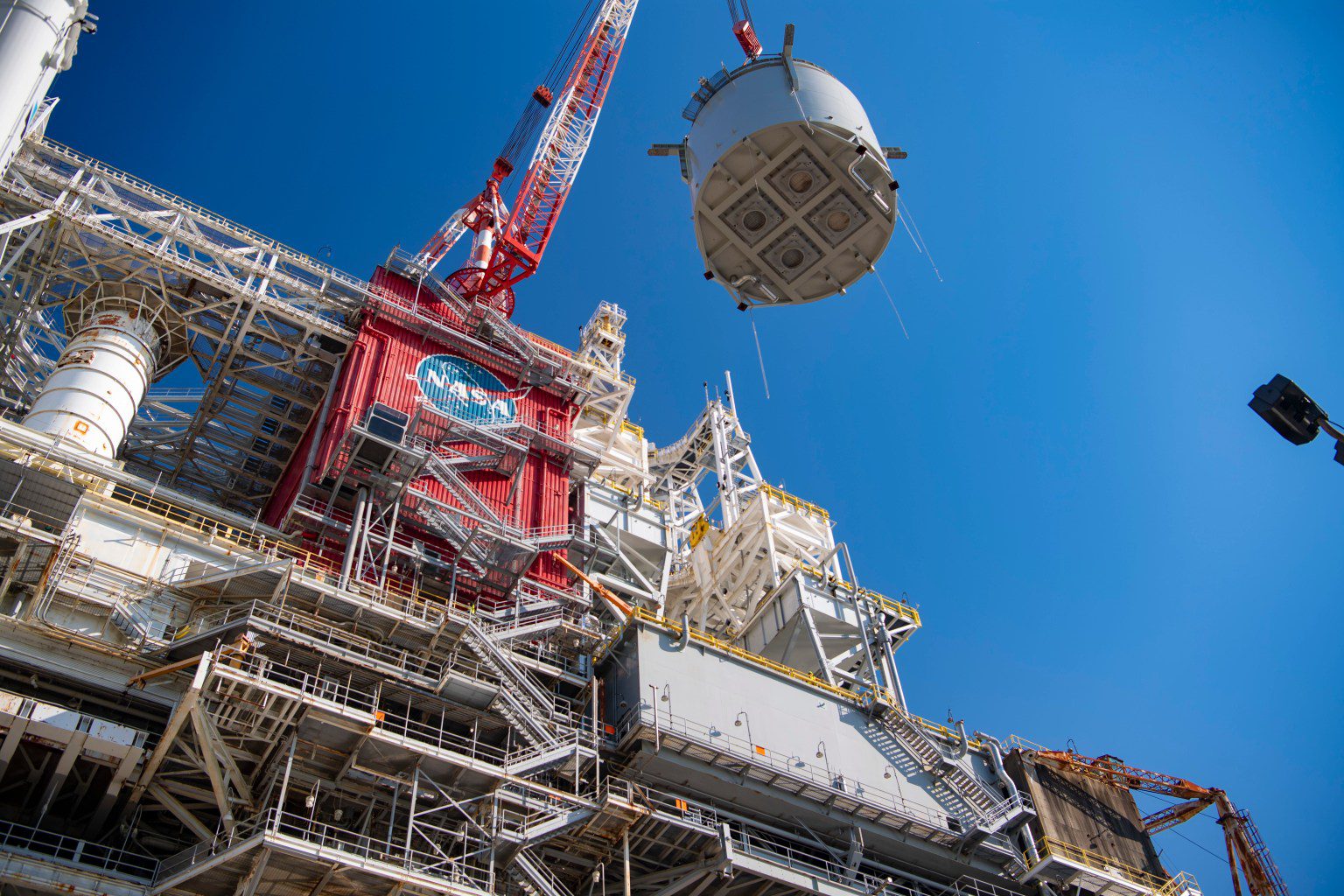 interstage simulator component suspended in air by crane