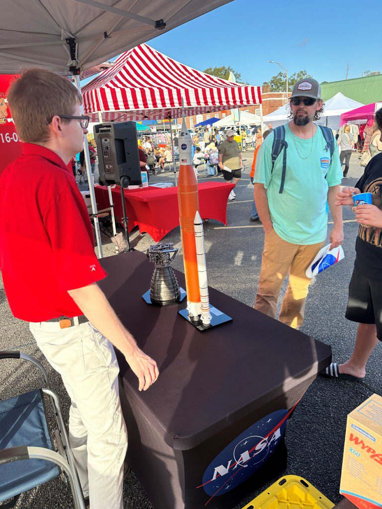 A NASA Stennis representative engages with the Artemis Generation at the Picayune Street Fair