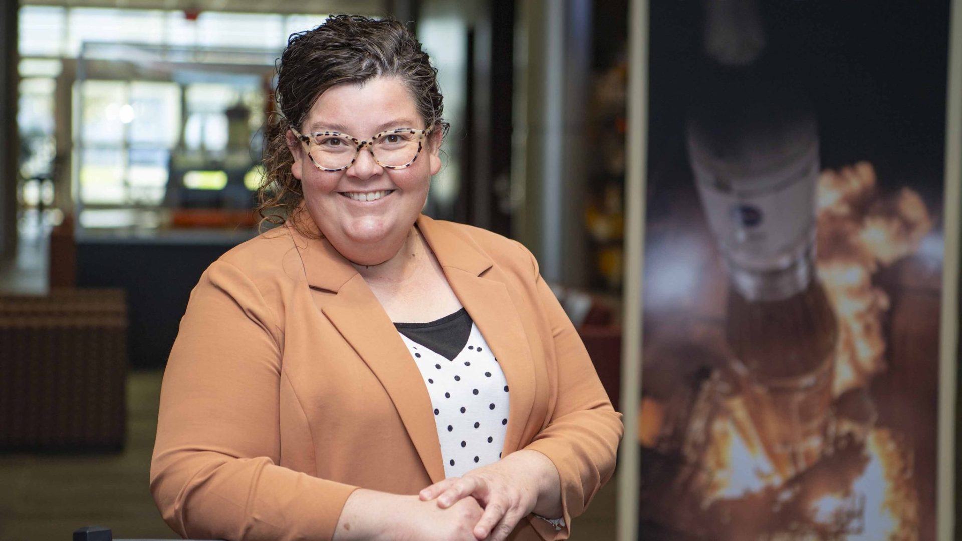 Tessa Keating poses for a portrait wearing a caramel-colored jacket