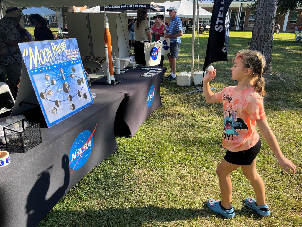 A young participant playing a game to identify different phases of the Moon and learned more about NASA’s return to the Moon at the Wild Things event celebrating National Wildlife Refuge Week in Lacombe, Louisiana.