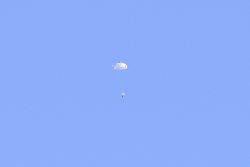 Capsule descending with parachute