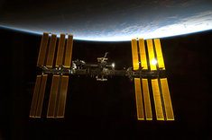 Sunlight glints off the International Space Station.
